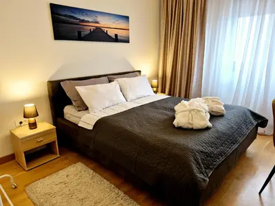 a bedroom with a bed with a stuffed animal on it at Apartment BW Maria Belgrade in Sajmište