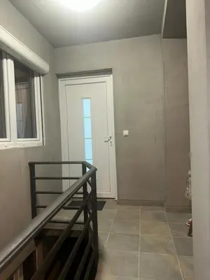 a hallway with a staircase and a white door at STAN Beograd in Belgrade