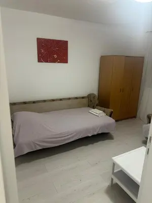 a bedroom with a bed and a painting on the wall at STAN Beograd in Belgrade