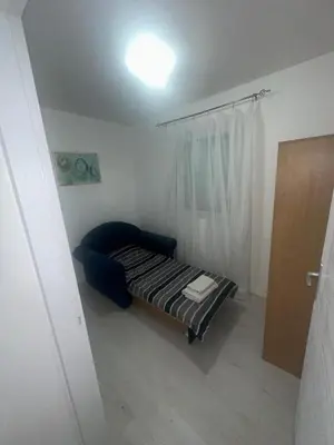 a small bed in a room with a window at STAN Beograd in Belgrade
