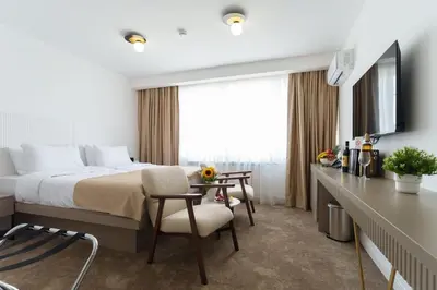 a hotel room with a bed and a desk at Move In Apartments - ApartHotel Belgrade in Belgrade