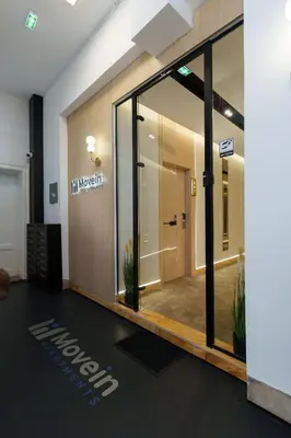 a lobby with a large glass door in a building at Move In Apartments - ApartHotel Belgrade in Belgrade