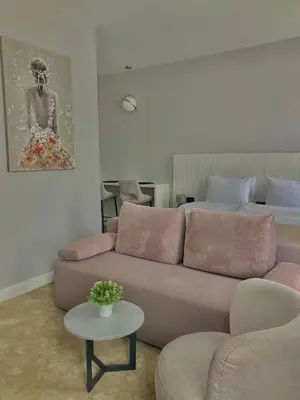 a living room with a couch and a table at Move In Apartments - ApartHotel Belgrade in Belgrade
