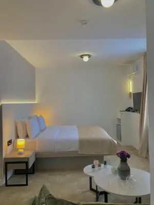a hotel room with a bed and a table at Move In Apartments - ApartHotel Belgrade in Belgrade