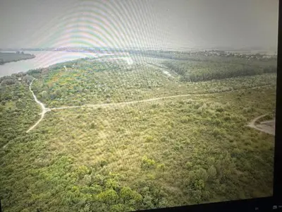 an aerial view of a forested area with a rainbow at Danube Oasis Stevantown 1 in Stari Banovci