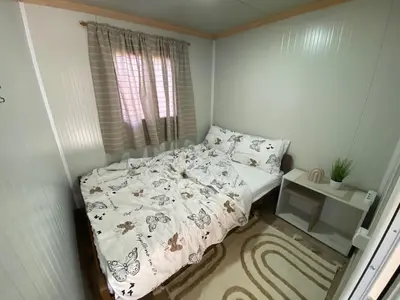 a small bedroom with a bed and a window at Danube Oasis Stevantown 1 in Stari Banovci