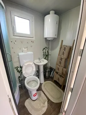 a bathroom with a toilet and a sink at Danube Oasis Stevantown 1 in Stari Banovci