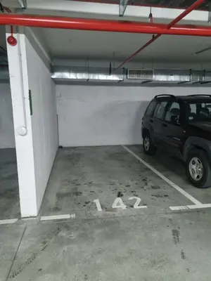 a parking garage with a car parked in it at Kaktus in Bežanija