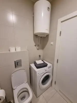 a small bathroom with a toilet and a sink at Kaktus in Bežanija