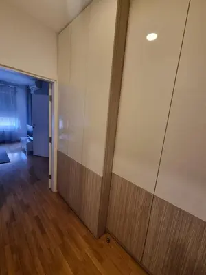 an empty room with a wall with a wooden partition at Kaktus in Bežanija