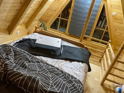 a bedroom with a bed with a laptop on it at Danube Oasis Stevantown 3 in Stari Banovci
