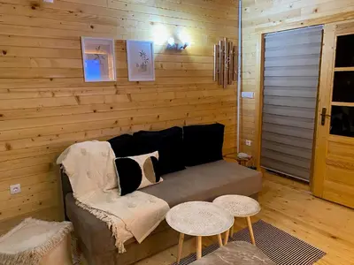 a living room with a couch and two tables at Danube Oasis Stevantown 3 in Stari Banovci