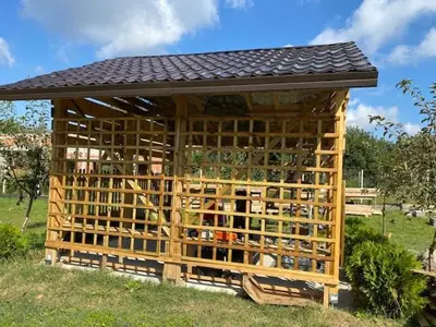 a wooden building with a roof on top of it at Danube Oasis Stevantown 3 in Stari Banovci
