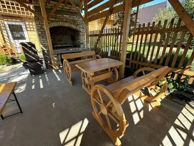 a patio with a wooden table and a table and benches at Danube Oasis Stevantown 3 in Stari Banovci