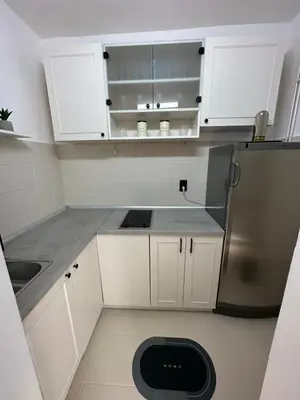 a kitchen with white cabinets and a stainless steel refrigerator at Banovo Brdo Premium in Čukarica