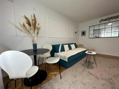 a living room with a couch and a table and chairs at Banovo Brdo Premium in Čukarica