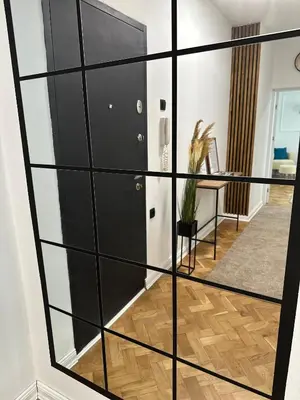 a room with a glass partition with a door at Banovo Brdo Premium in Čukarica