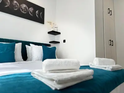 a bedroom with a bed with towels on it at Banovo Brdo Premium in Čukarica