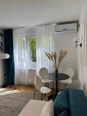 a living room with a couch and a table and chairs at Banovo Brdo Premium in Čukarica