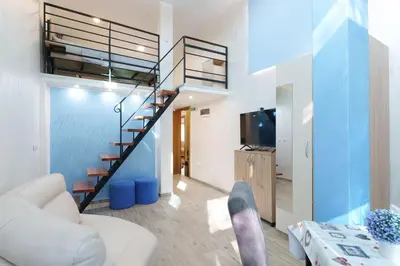 a living room with a staircase in a house at Step rooms apt spa in Belgrade