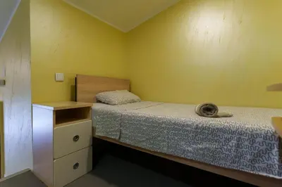 a small bedroom with two beds and a dresser at Step rooms apt spa in Belgrade