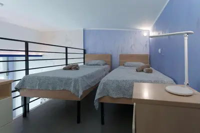 two beds in a room with a balcony at Step rooms apt spa in Belgrade