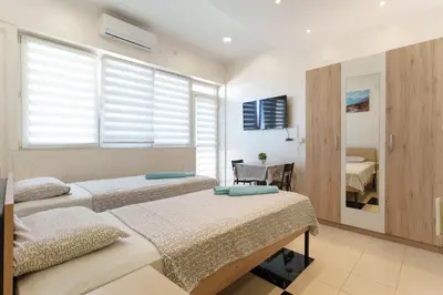 a bedroom with two beds and a window at Step rooms apt spa in Belgrade