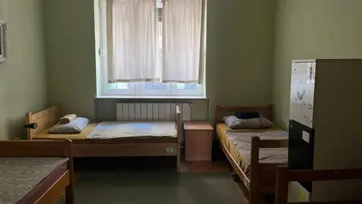 two beds in a room with a window at HostelChe Hostel in Belgrade