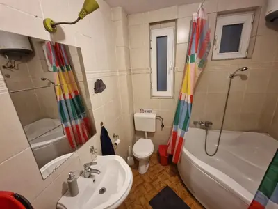 a bathroom with a sink and a tub and a toilet at HostelChe Hostel in Belgrade