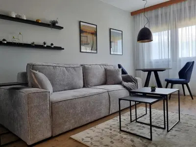 a living room with a couch and a table at The nest 31 in Irig