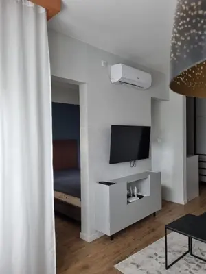 a living room with a tv and a couch at The nest 31 in Irig