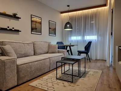 a living room with a couch and a table at The nest 31 in Irig