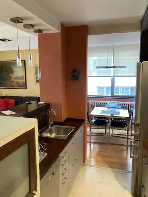 a kitchen with a sink and a kitchen with a table at Waterfront with free parking in Sajmište