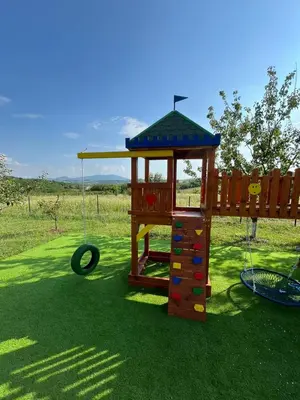 a playground with a swing and a tire at Panorama Kosmaj in Sopot