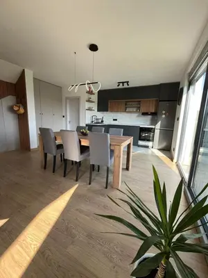 a kitchen and dining room with a table and chairs at Panorama Kosmaj in Sopot