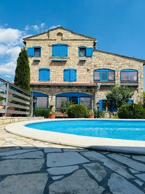a building with a swimming pool in front of a building at Stone villa in Fruška gora in Irig