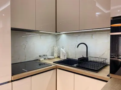 a kitchen with white cabinets and a sink at Apartmani Kolaković in Arandjelovac