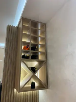 a shelf in a wall with wine bottles at Apartmani Kolaković in Arandjelovac