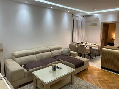 a living room with a couch and a table at Apartmani Kolaković in Arandjelovac