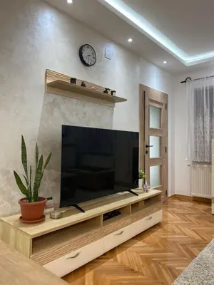 a living room with a large flat screen tv at Apartmani Kolaković in Arandjelovac
