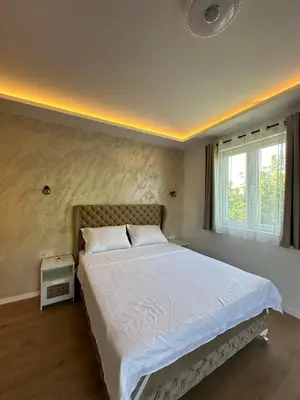 a bedroom with a large bed and a window at Apartman Igor in Surčin