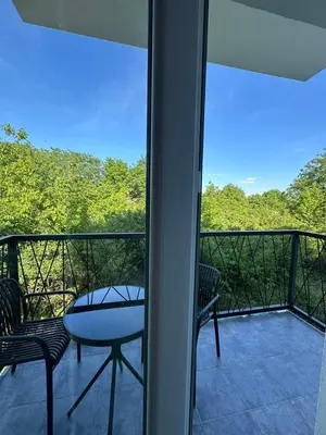 a balcony with a table and chairs and a view at Apartman Igor in Surčin