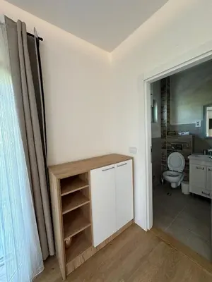 a bathroom with a sink and a toilet in a room at Apartman Igor in Surčin