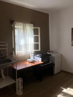 a kitchen with a table and a microwave and a window at Cica Vintage Eco House Near Lake in Crkvine