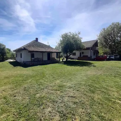 a house with a large yard in front of it at Cica Vintage Eco House Near Lake in Crkvine
