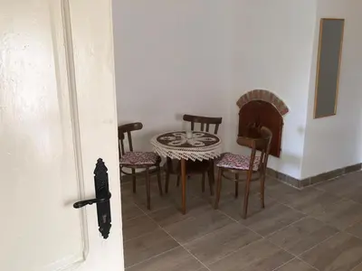 a room with a table and chairs in a room at Cica Vintage Eco House Near Lake in Crkvine
