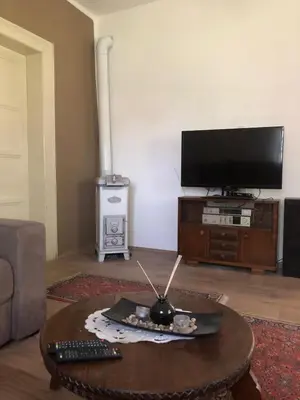 a living room with a tv and a coffee table at Cica Vintage Eco House Near Lake in Crkvine