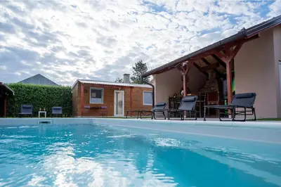 a swimming pool with chairs and a house at Seosko turističko domaćinstvo Tisa i Begej in Kni°anin
