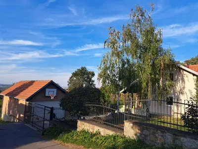 a house with a fence and a tree at Ramonda house in Brestovik