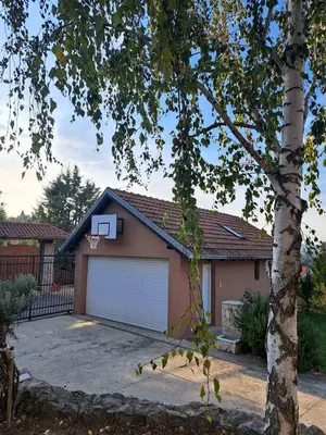 a garage with a basketball hoop on top of it at Ramonda house in Brestovik